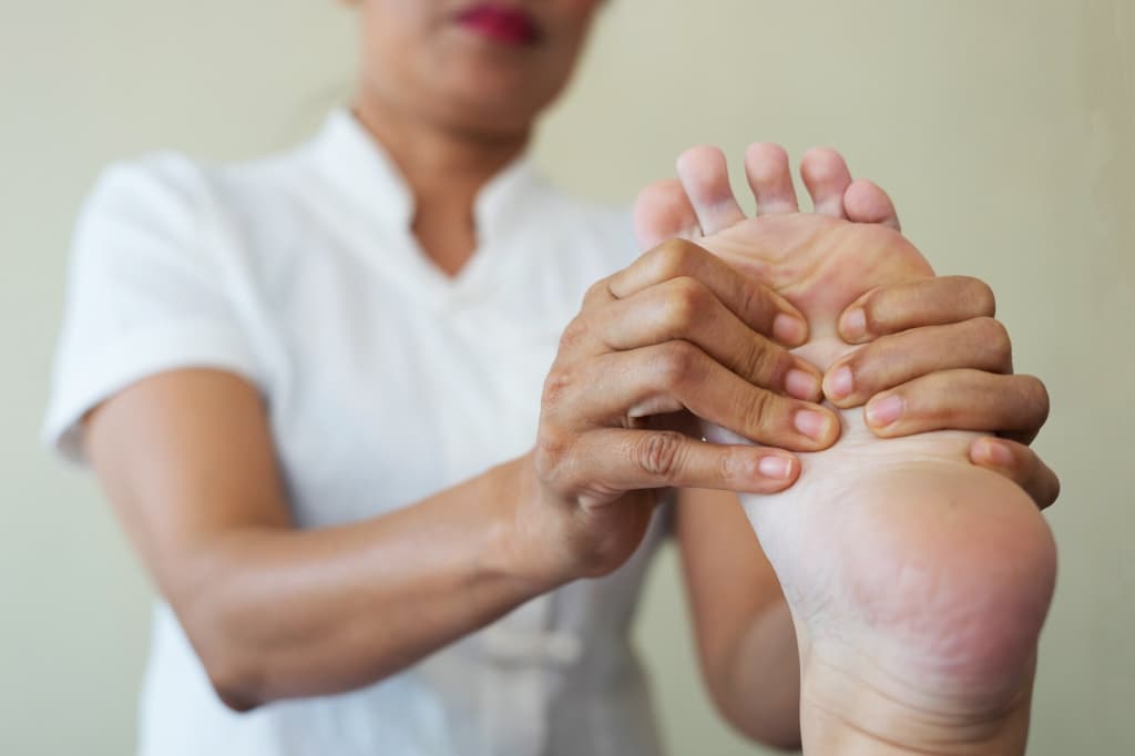 Close-up of a doctor giving a foot massage