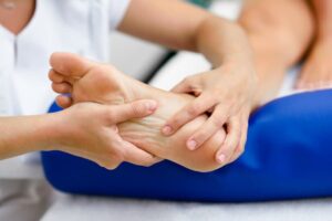 Doctor is Giving a Foot Massage to the Patient