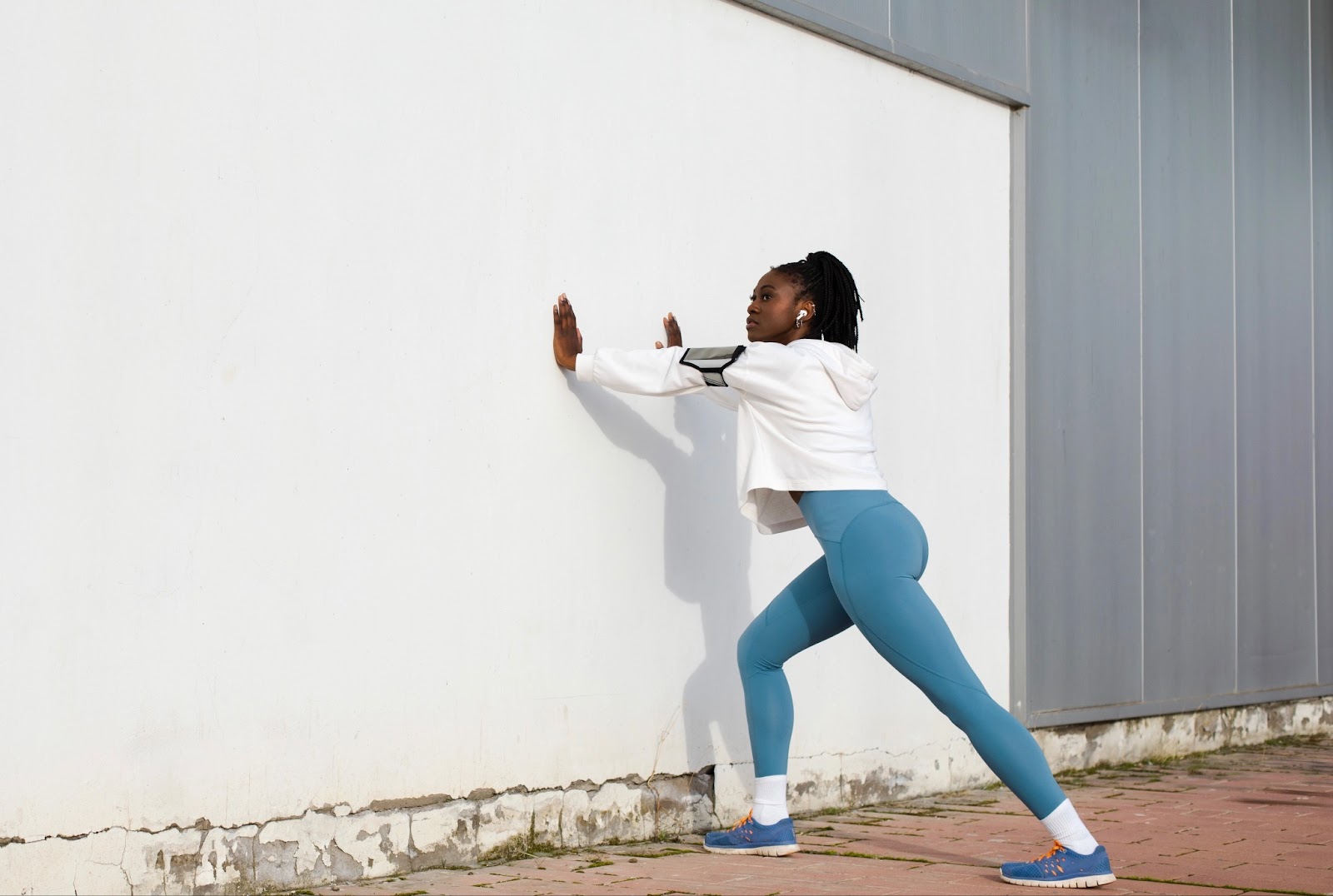 Girl doing Achilles exercise near the wall